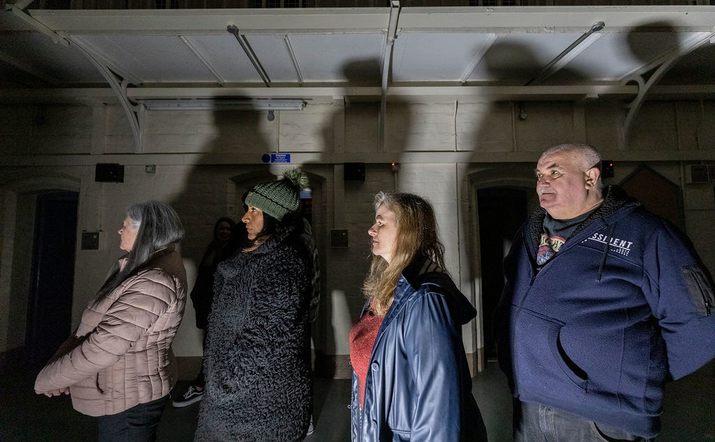 Visitors taking part in Ghost Hunting Behind Bars at Shrewsbury Prison