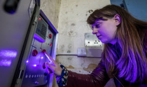 Valentine's Day Ideas: A visitor trying to work out a clue during The Cell Escape Room.